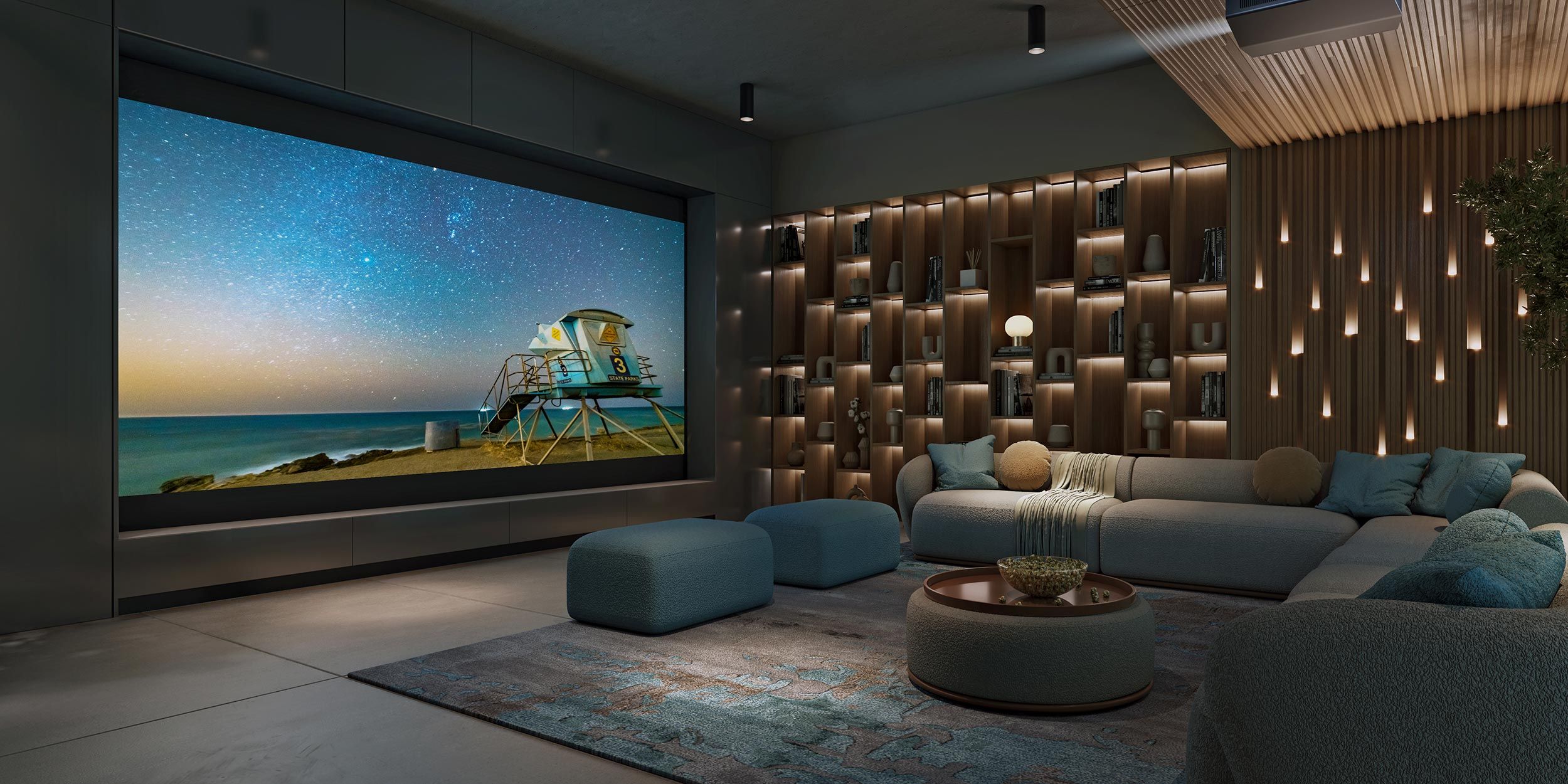 A luxurious home theater setup with a large screen displaying a beach scene and ambient lighting on the walls.